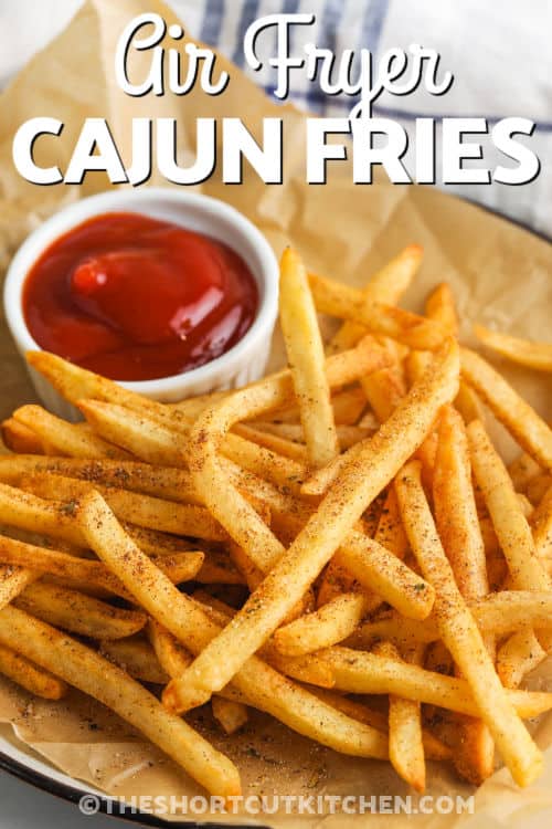 Cajun Fries on a plate with ketchup and writing