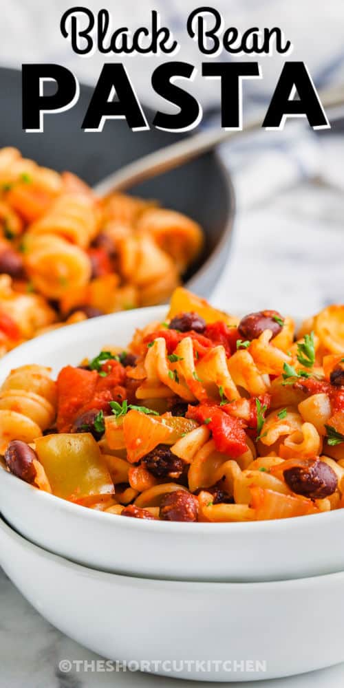 plated Black Bean Pasta with pan full in the background with a title