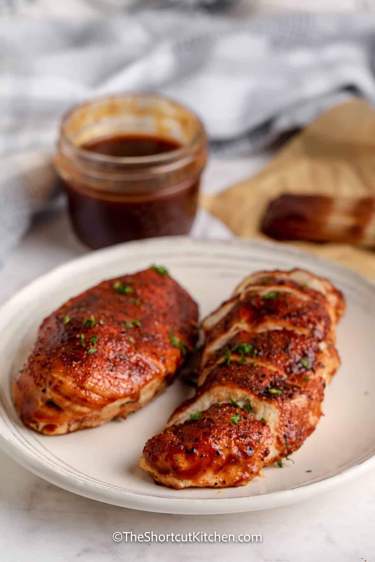 air fryer bbq chicken on a plate topped with parsley