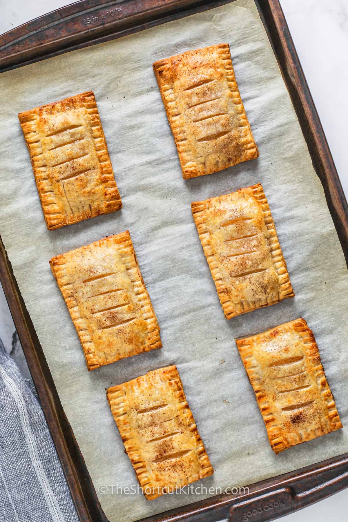 cooked Apple Hand Pies on a sheet pan