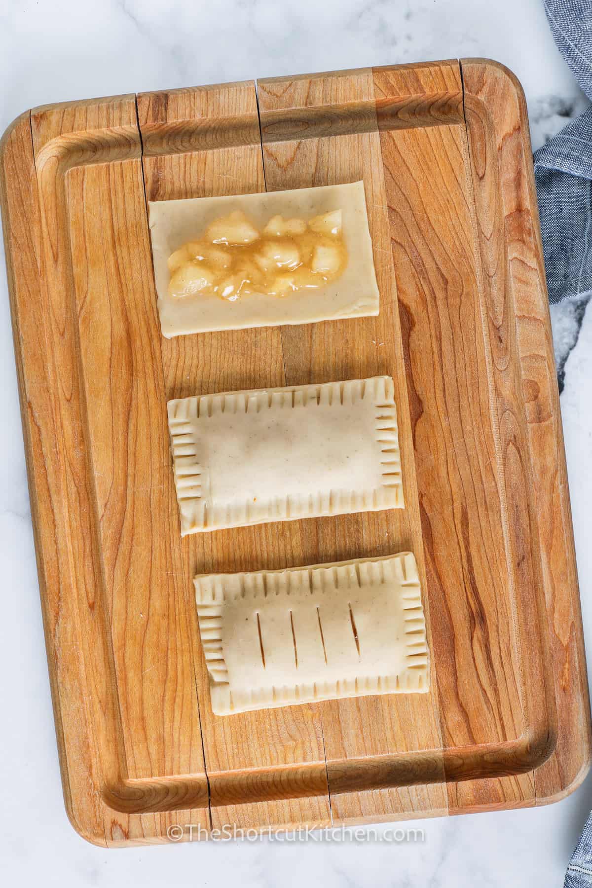 filling pie crusts with apple filling to make Apple Hand Pies