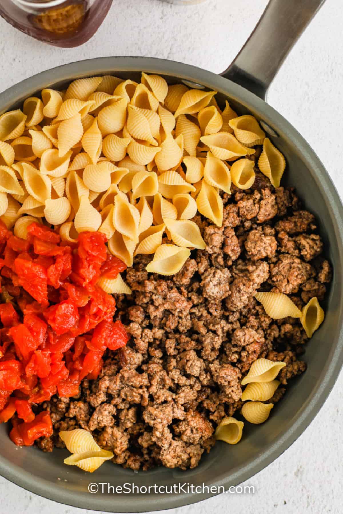 Cheesy Ground Beef Pasta ingredients in a pot.
