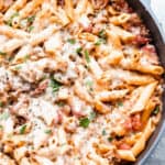 Italian Sausage Pasta in a skillet, garnished with fresh parsley