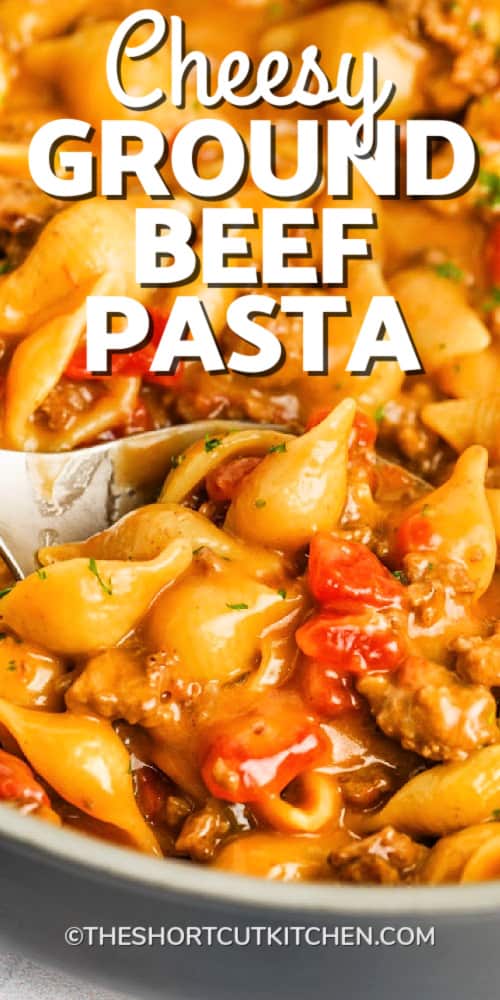 Cheesy Ground Beef Pasta being scooped from a pan with a spoon, with a title