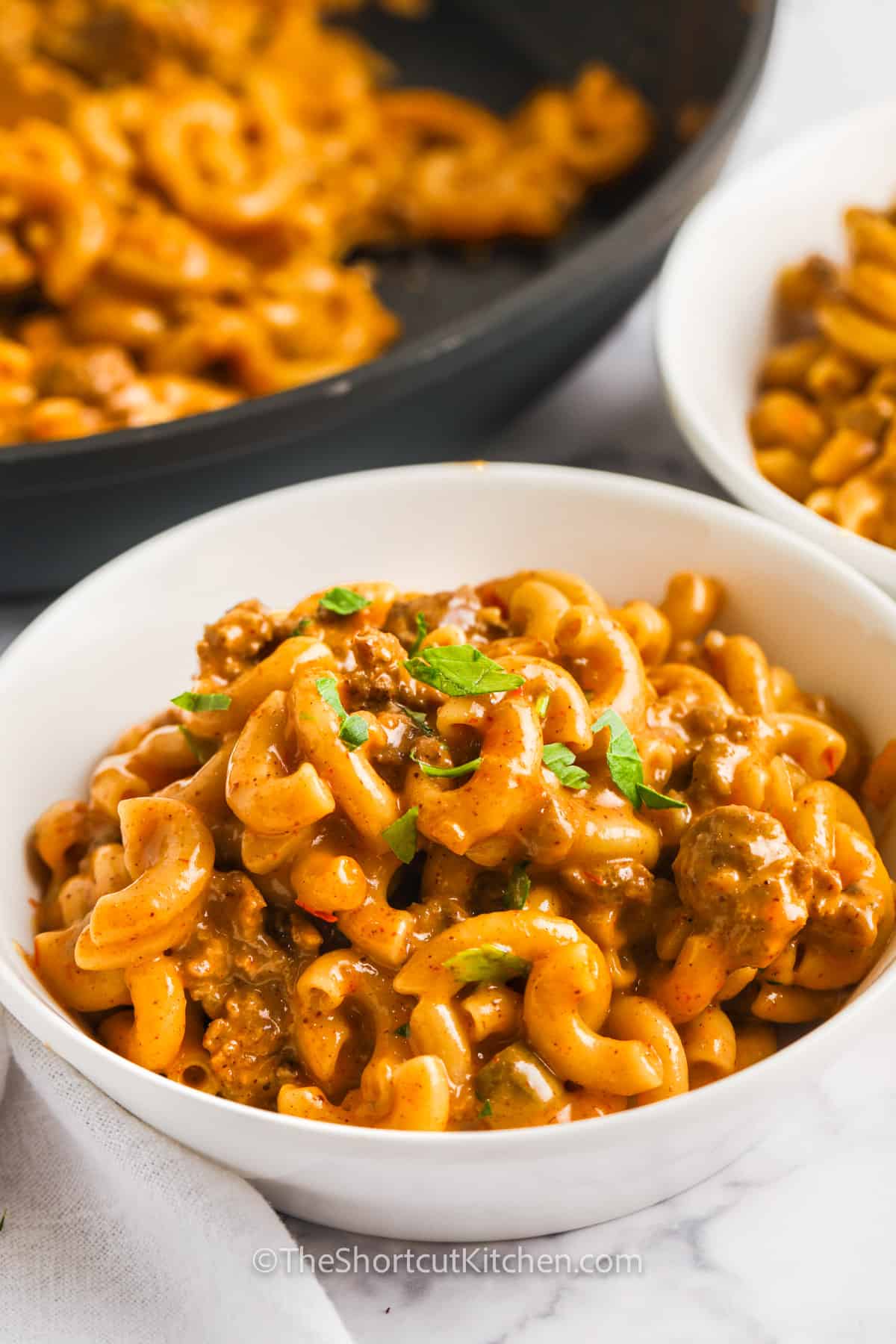 bowl of Taco Mac and Cheese with pan full in the back