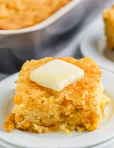 slice of Cornbread Casserole with butter on a plate