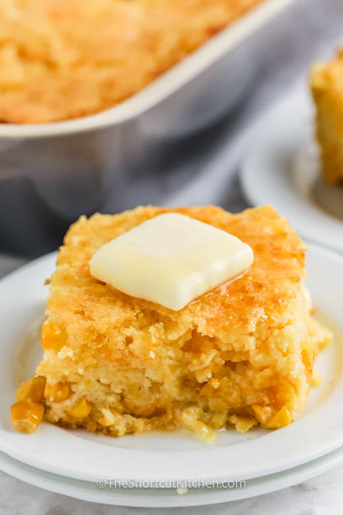 slice of Cornbread Casserole with butter on a plate