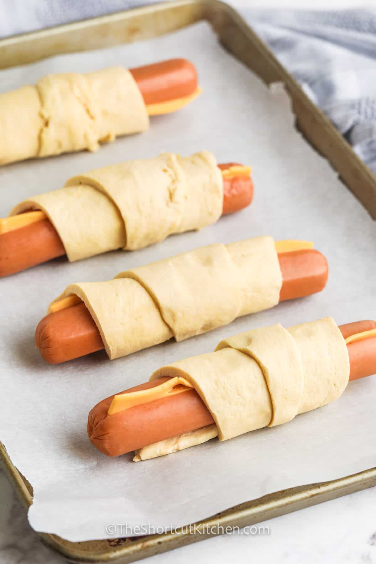Crescent Roll Hot Dogs before cooking on a sheet pan