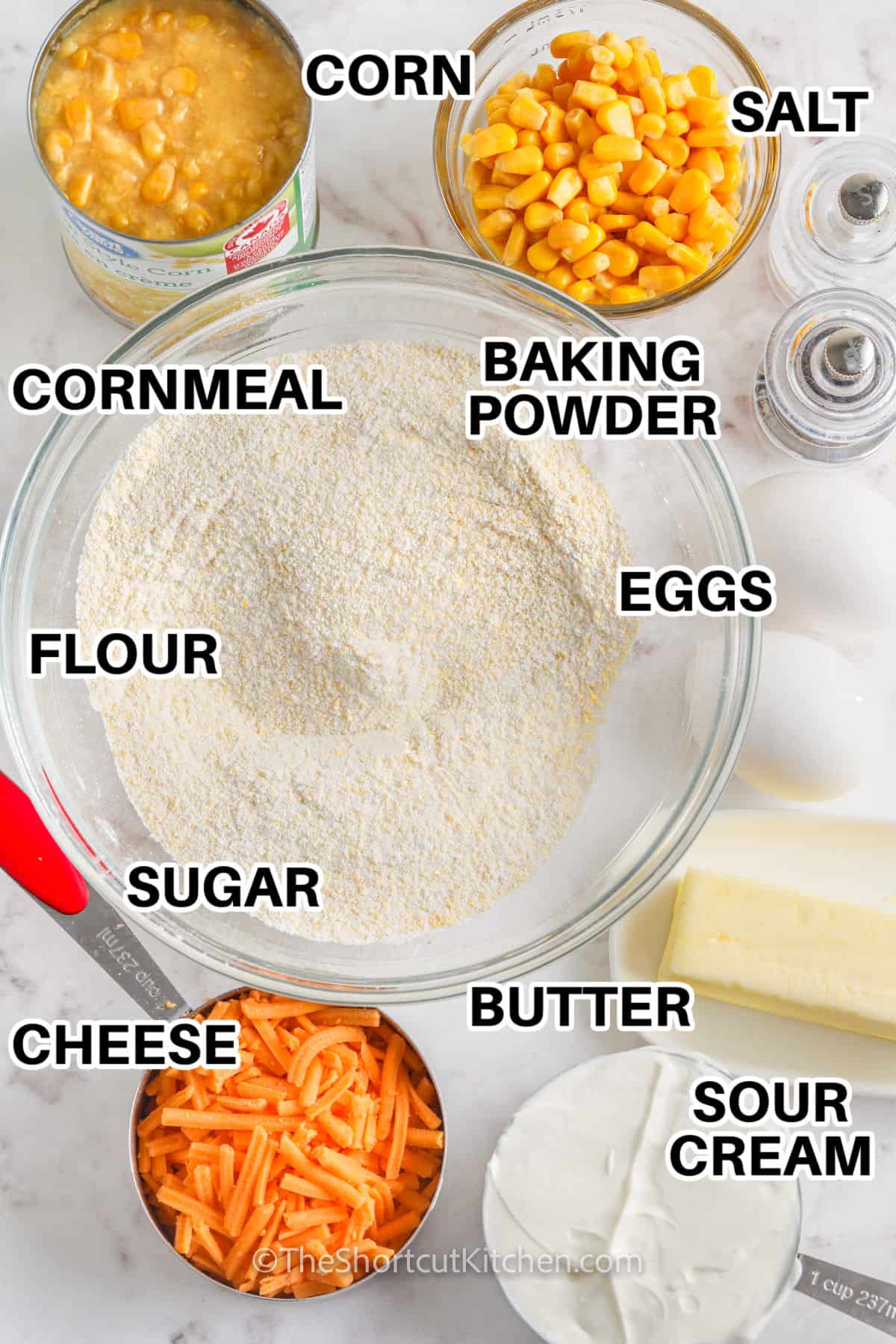 corn , cheese , sour cream , butter , sugar , flour , baking powder , salt , cornmeal and eggs with labels to make Cornbread Casserole