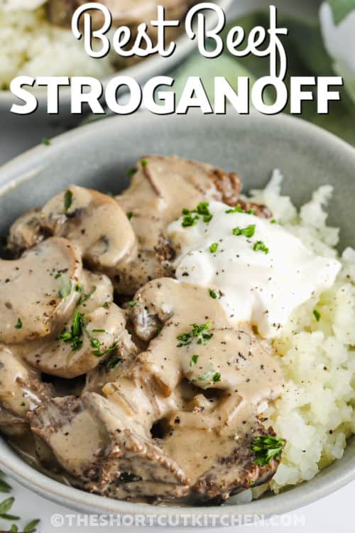 cooked Beef Stroganoff Recipe in a bowl with sour cream and a title