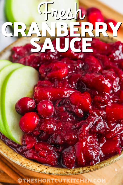 Fresh Cranberry Apple Sauce in a bowl with apple slices and a title