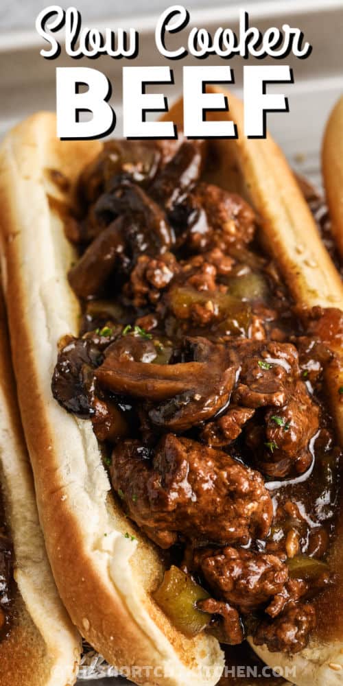 close up of Crock Pot Beef And Gravy in a bun with writing