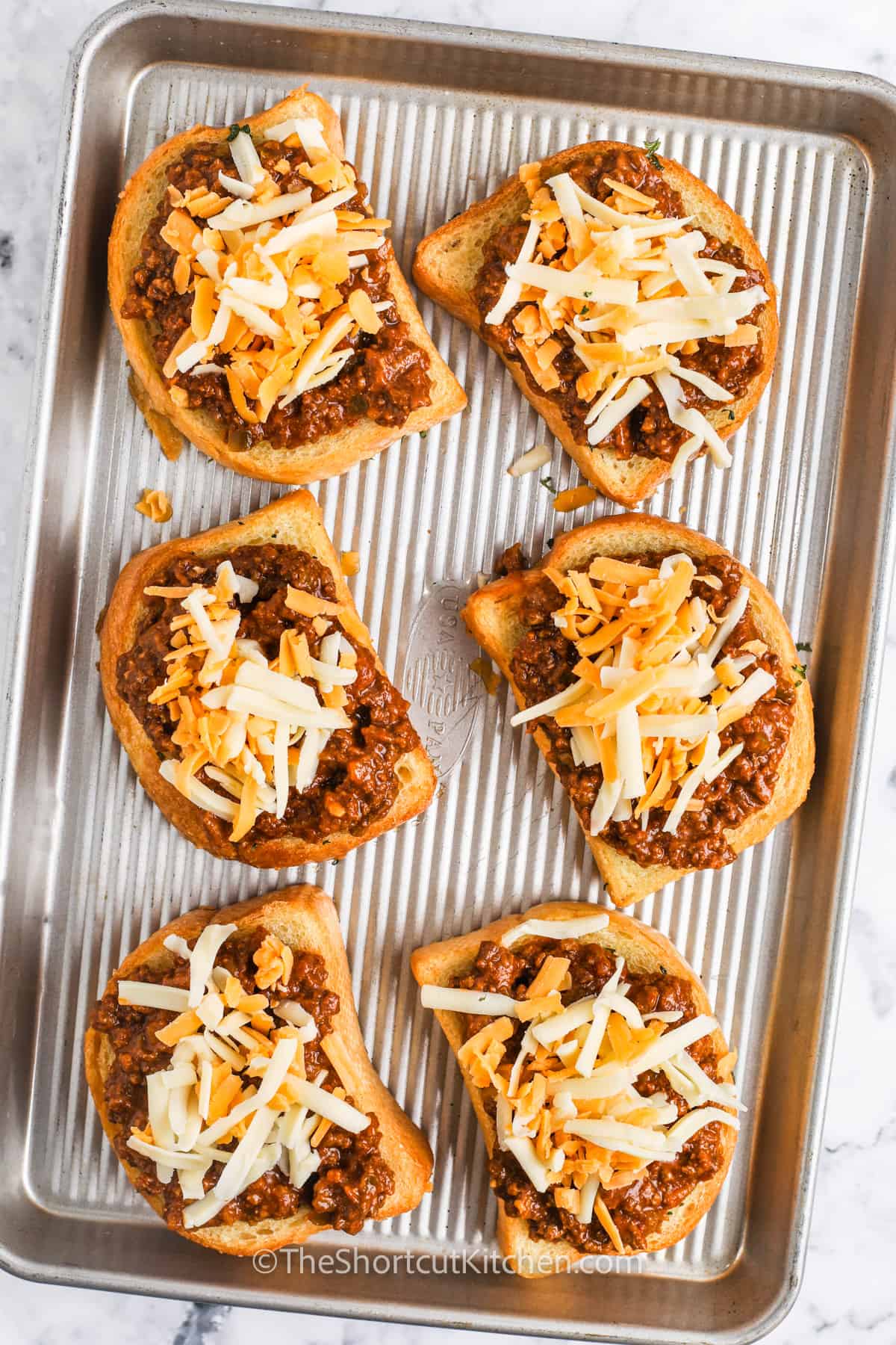 adding cheese to Texas Toast Sloppy Joes