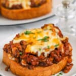 cooked Texas Toast Sloppy Joes on a plate with plate full in the back