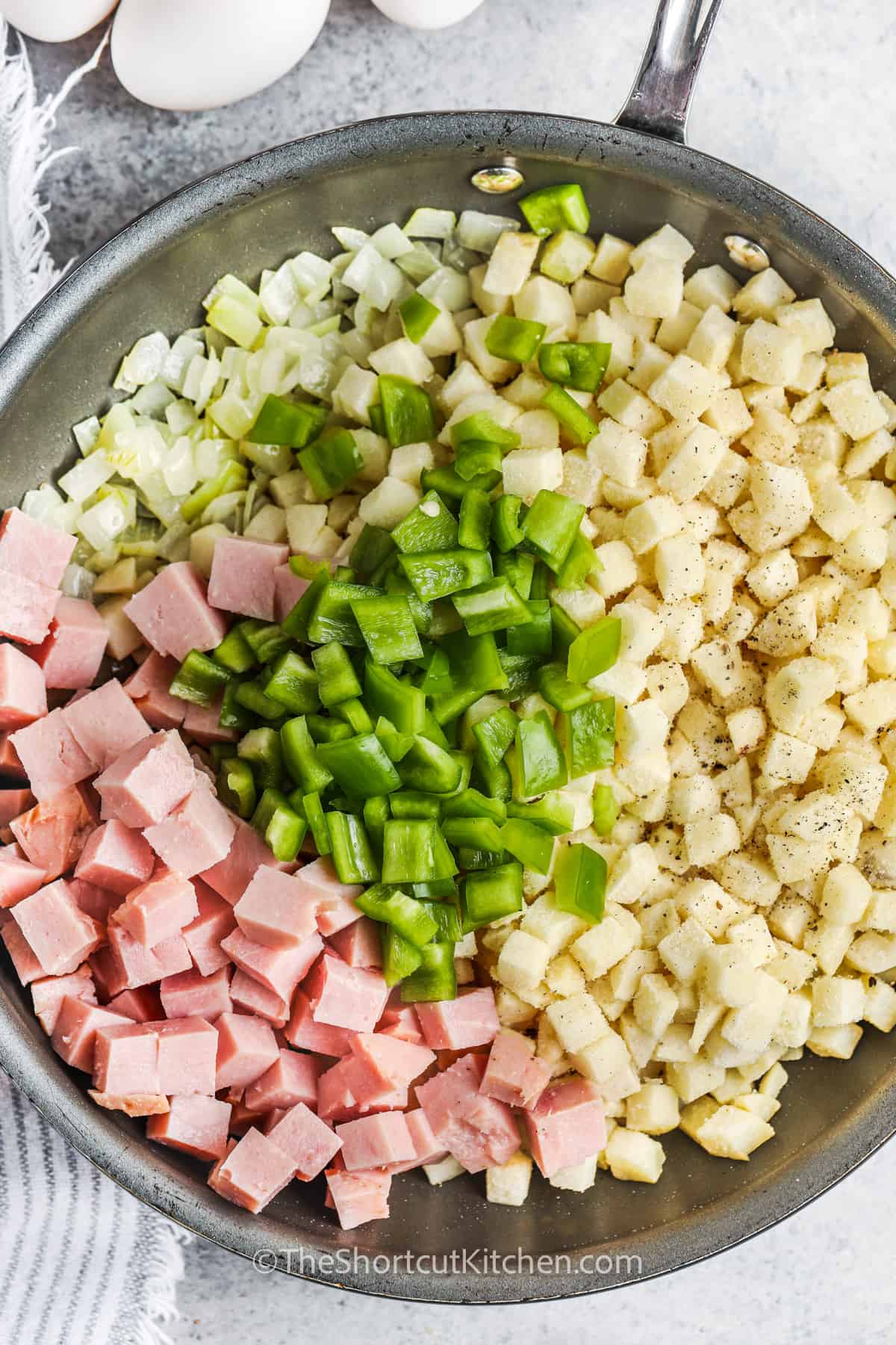 ingredients in a pan to make Breakfast Hash With Ham