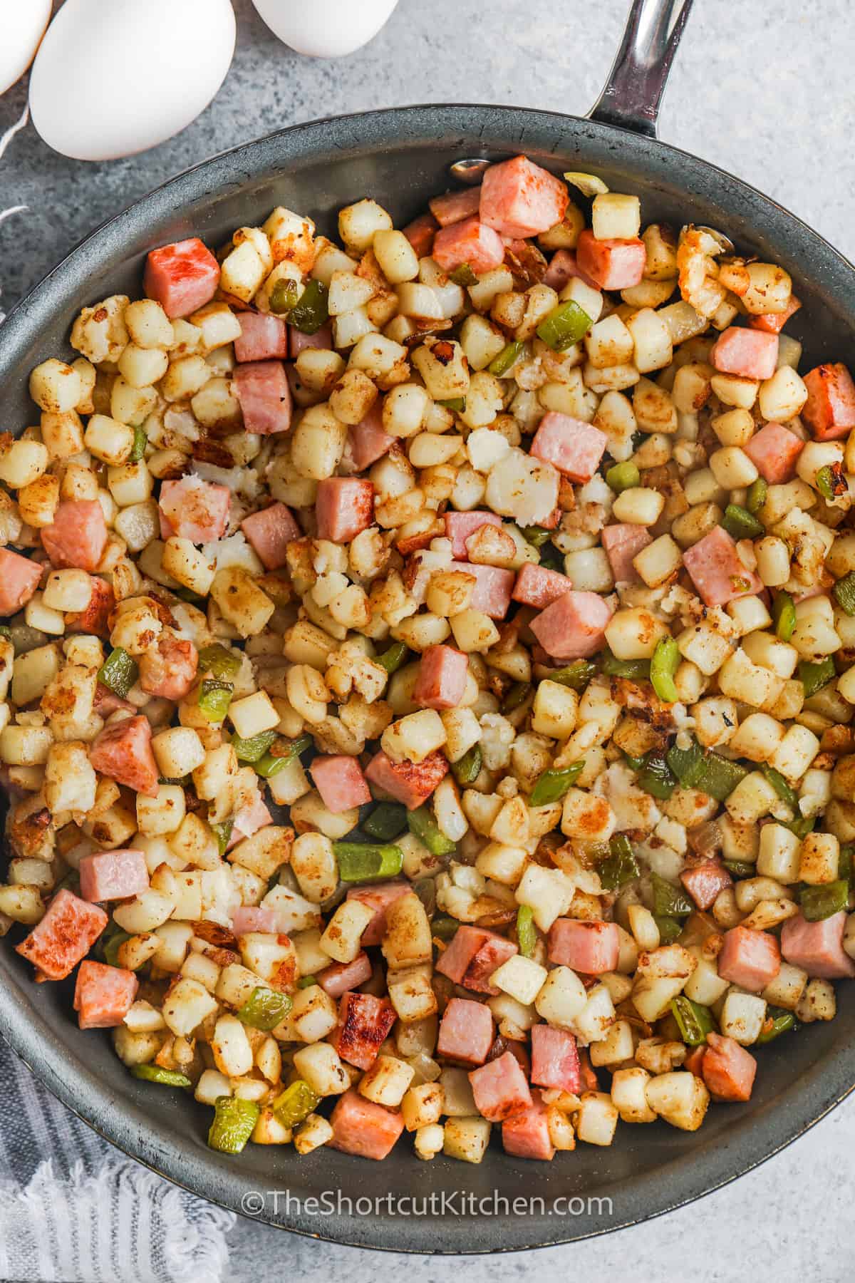 Breakfast Hash With Ham ingredients in the pan cooking