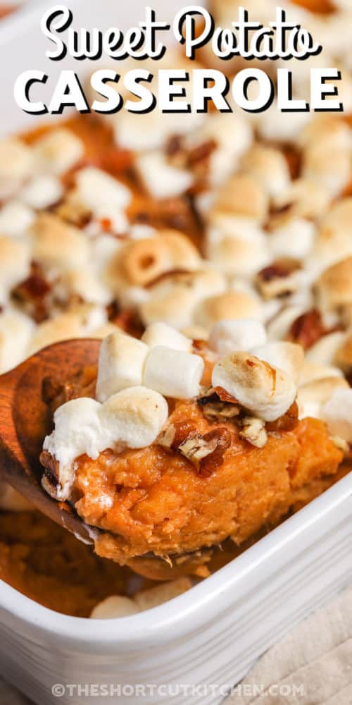 taking a spoonful of Canned Sweet Potato Casserole out of a casserole dish with writing