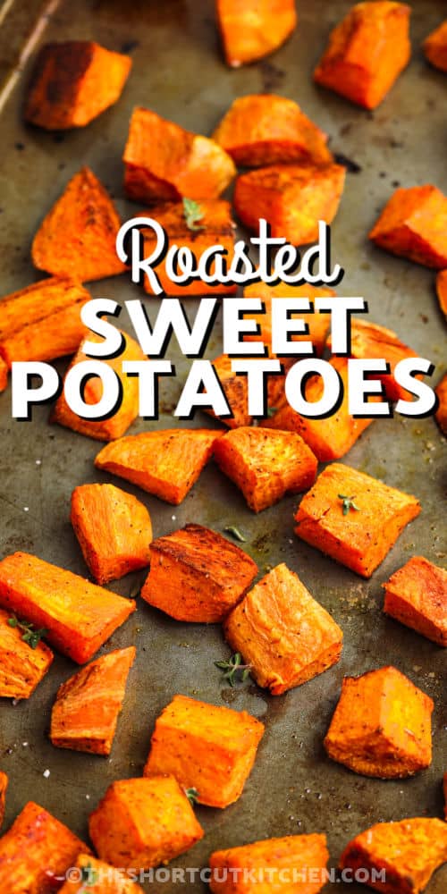 close up of baked Oven Roasted Sweet Potatoes on a sheet pan with writing