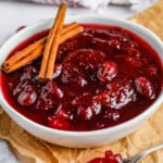 close up of Better Canned Cranberry Sauce in a bowl with a spoon full beside it