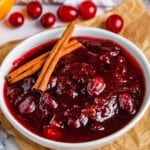 bowl of Better Canned Cranberry Sauce with cinnamon sticks