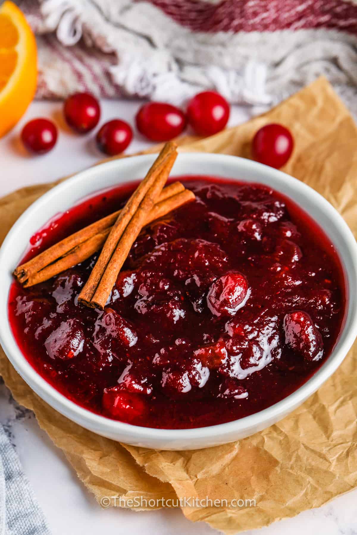 bowl of Better Canned Cranberry Sauce with cinnamon sticks