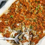 taking a spoonful of Canned Green Bean Casserole out of the casserole dish