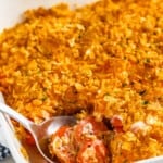 close up of Carrot Casserole in a casserole dish with a spoon taking some out