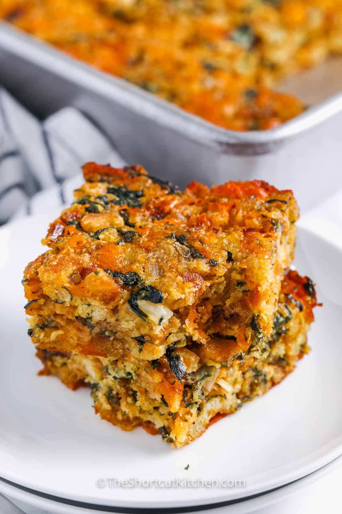 stack of Cheesy Spinach Stuffing Casserole slices