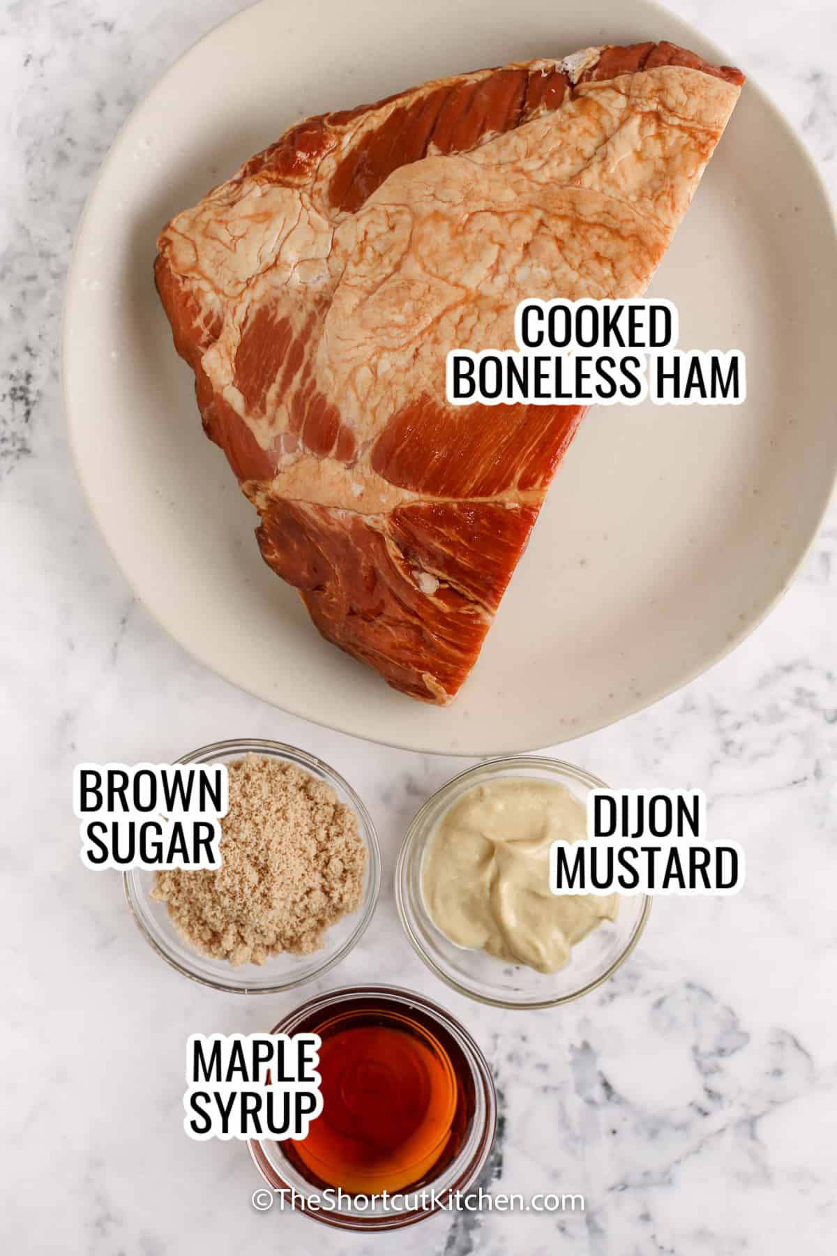 ingredients assembeled to make crockpot brown sugar ham, including ham, brown sugar, maple syrup, and dijon mustard