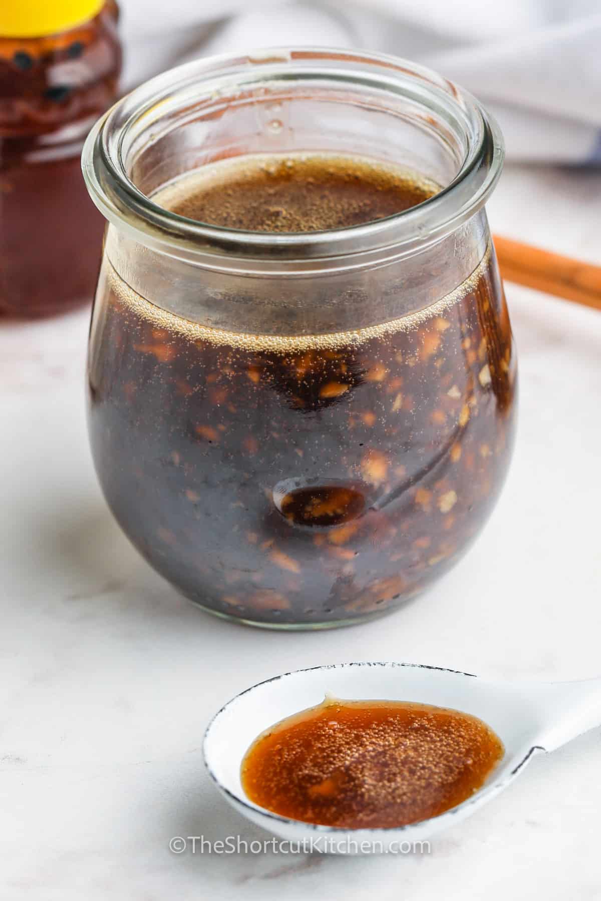 Homemade Honey Garlic Sauce in a jar and on a spoon