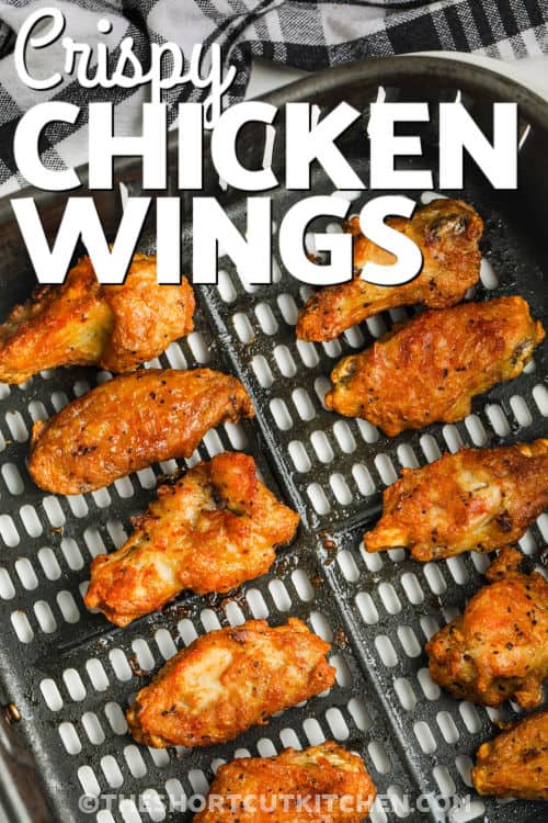 Air Fryer Frozen Chicken Wings in the fryer with a title