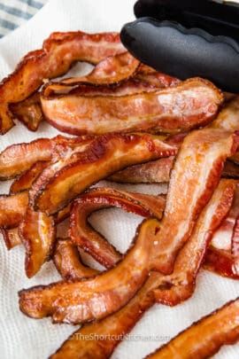 close up of cooked oven baked bacon resting on a paper towel