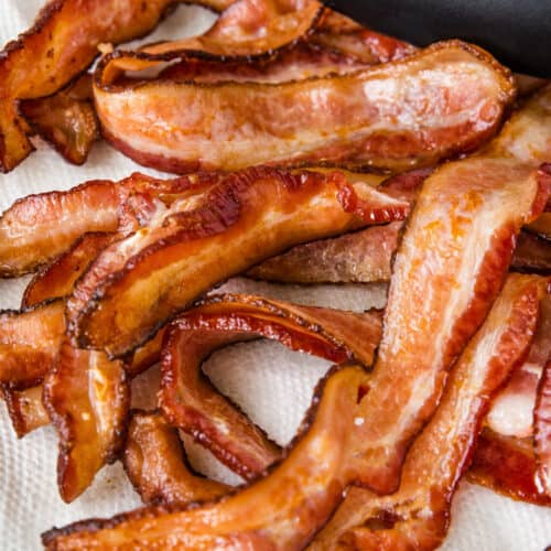 close up of cooked oven baked bacon resting on a paper towel