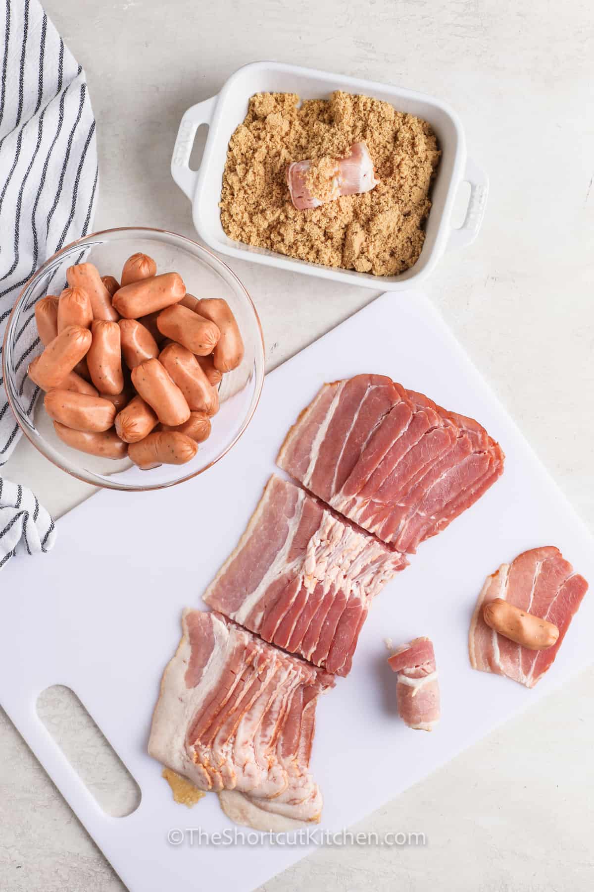 slicing bacon and coating in brown sugar to make Bacon Wrapped Smokies Recipe