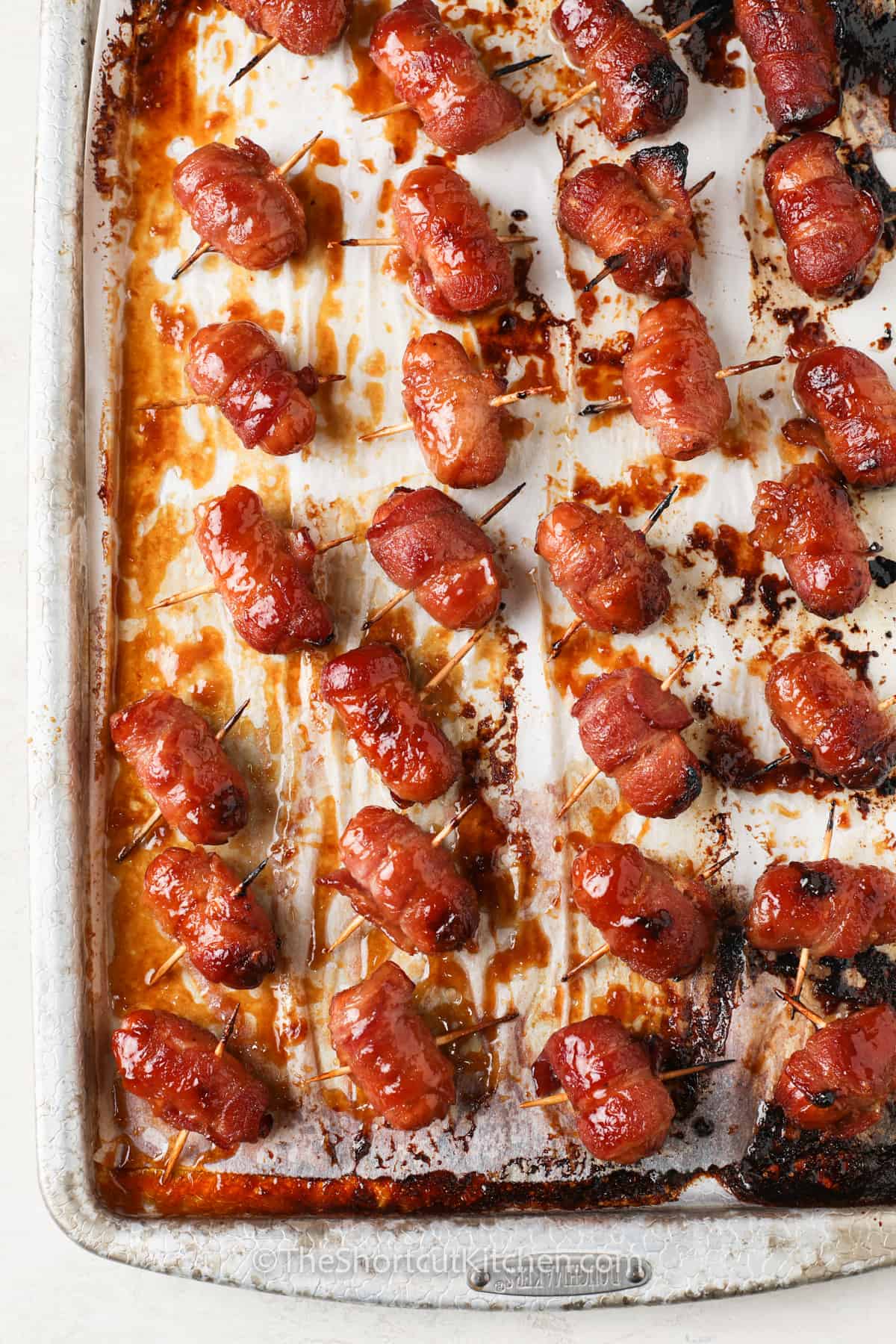 baked Bacon Wrapped Smokies Recipe on a sheet pan