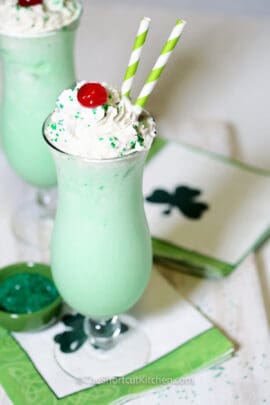 copycat shamrock shake recipe in a tall glass and topped with whipped cream