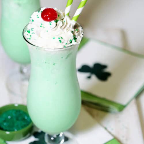 copycat shamrock shake recipe in a tall glass and topped with whipped cream