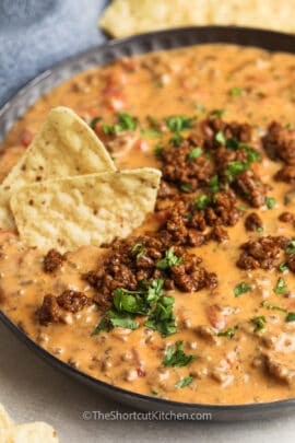 cooked Easy Beef Queso Dip in the pan with chips