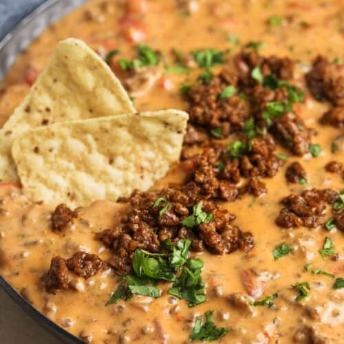cooked Easy Beef Queso Dip in the pan with chips