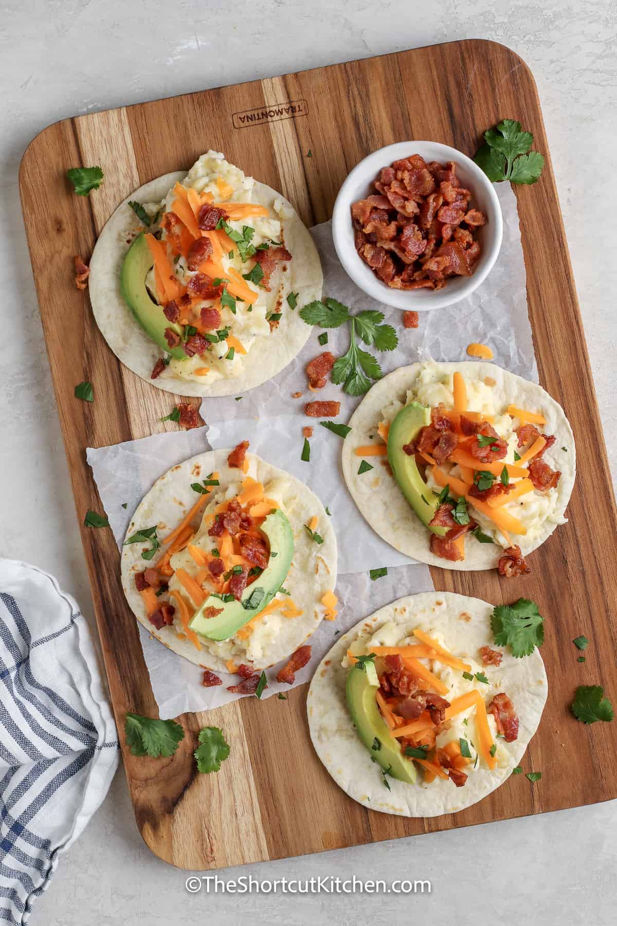 open breakfast tacos on a cutting board