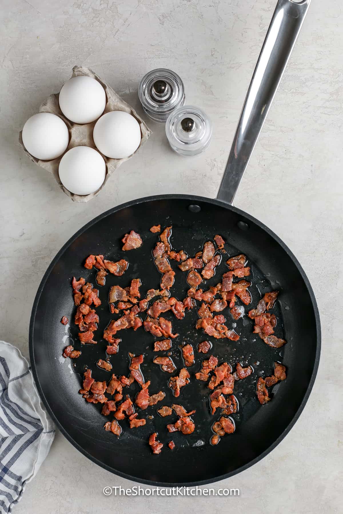 bacon pieces cooking in a pan
