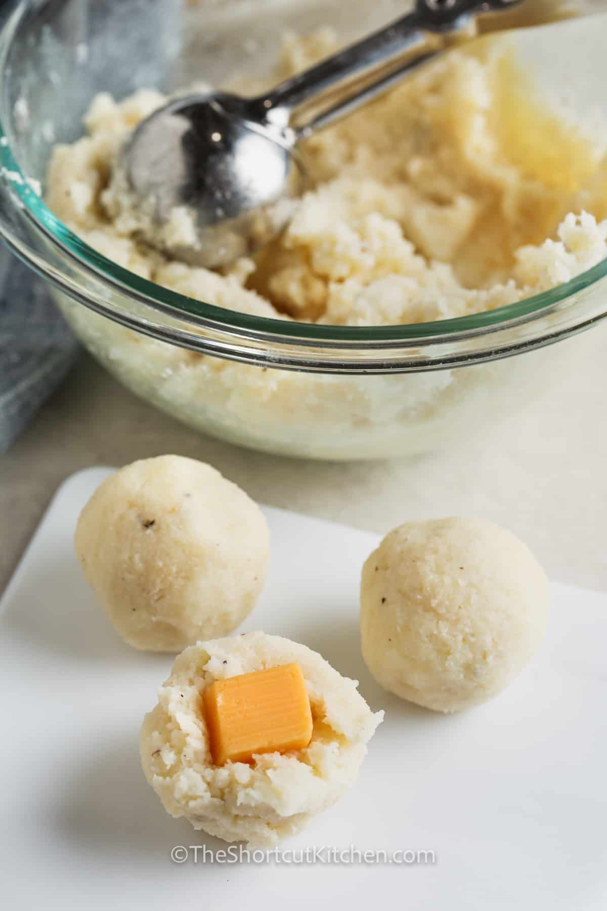 adding cheese to mashed potatoes to make Fried Mashed Potato Balls