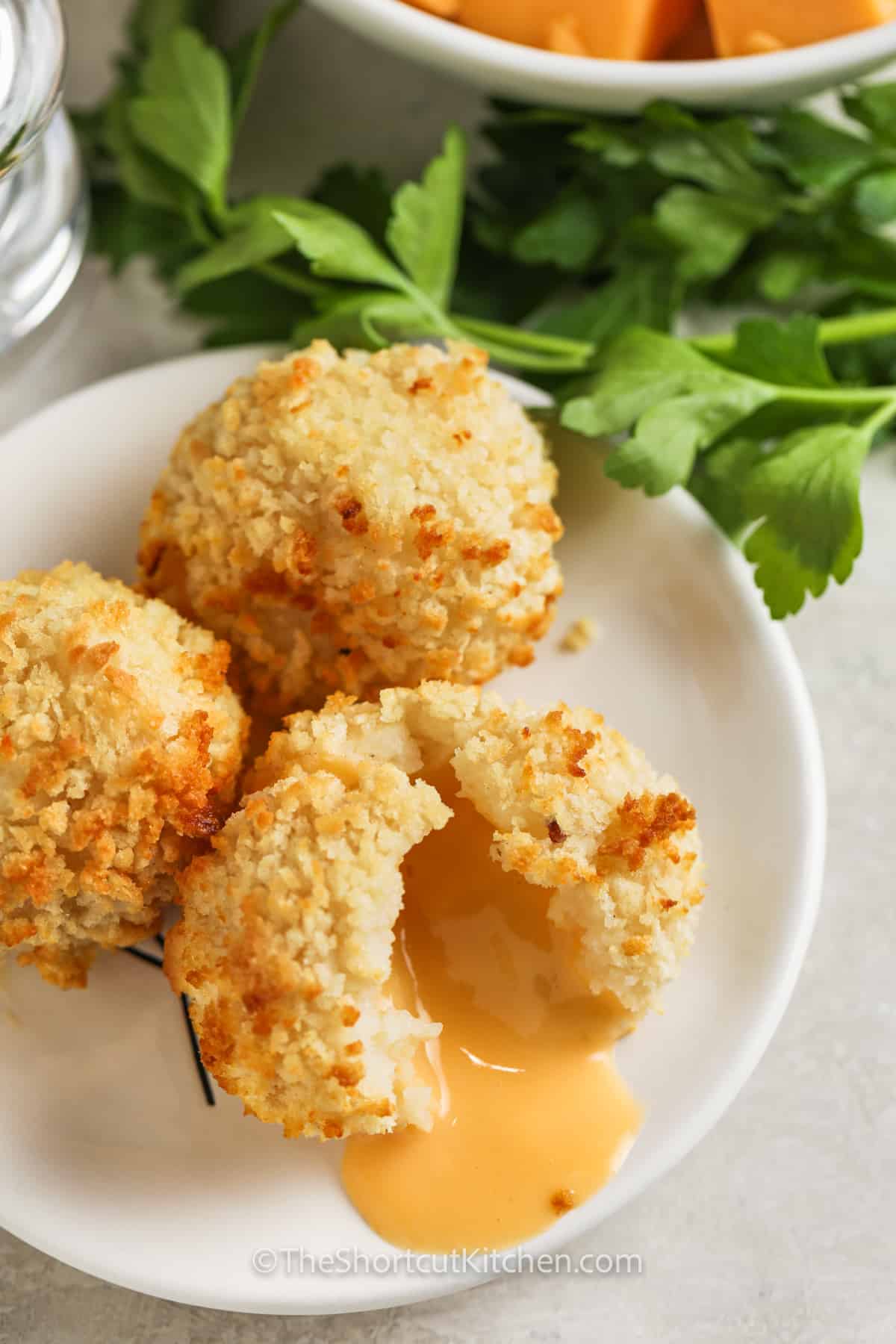 top view of Fried Mashed Potato Balls on a plate with one open