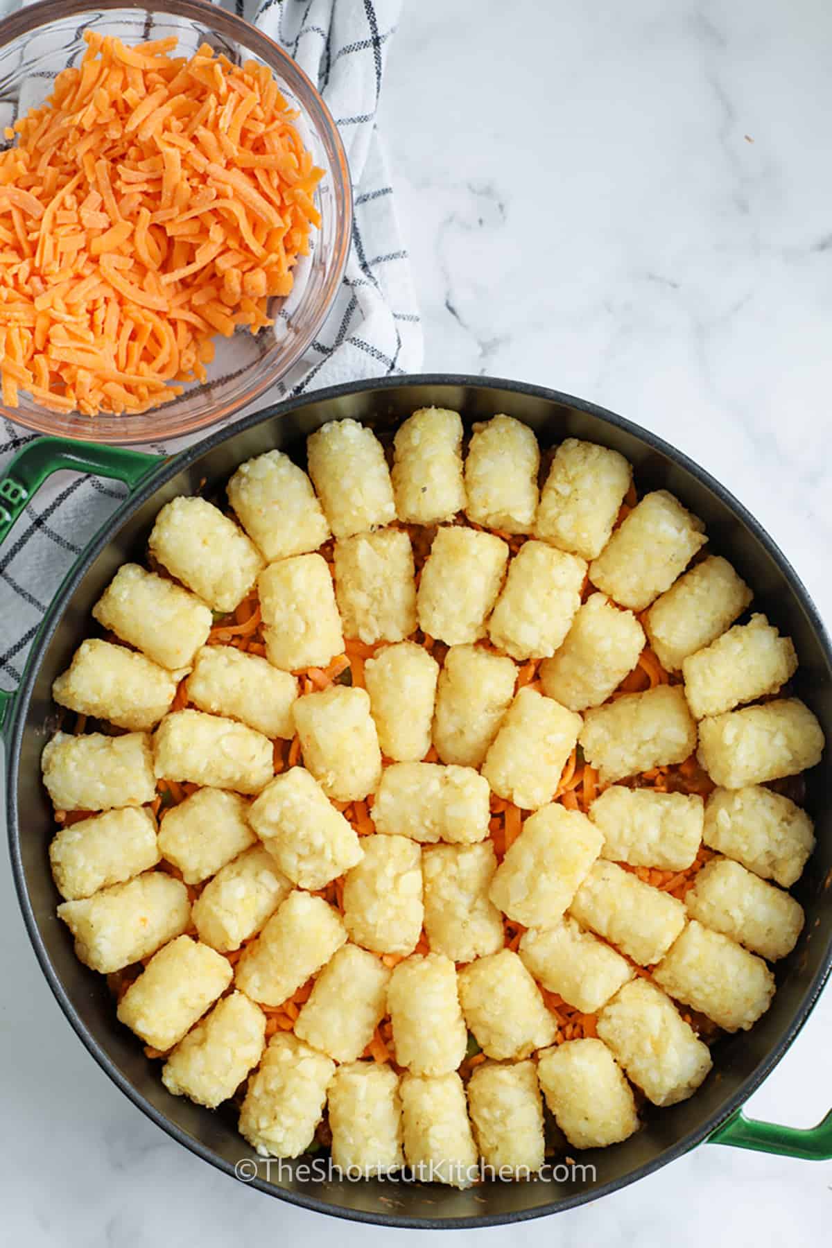 adding tater tots to pan to make Shortcut Shepherd’s Pie