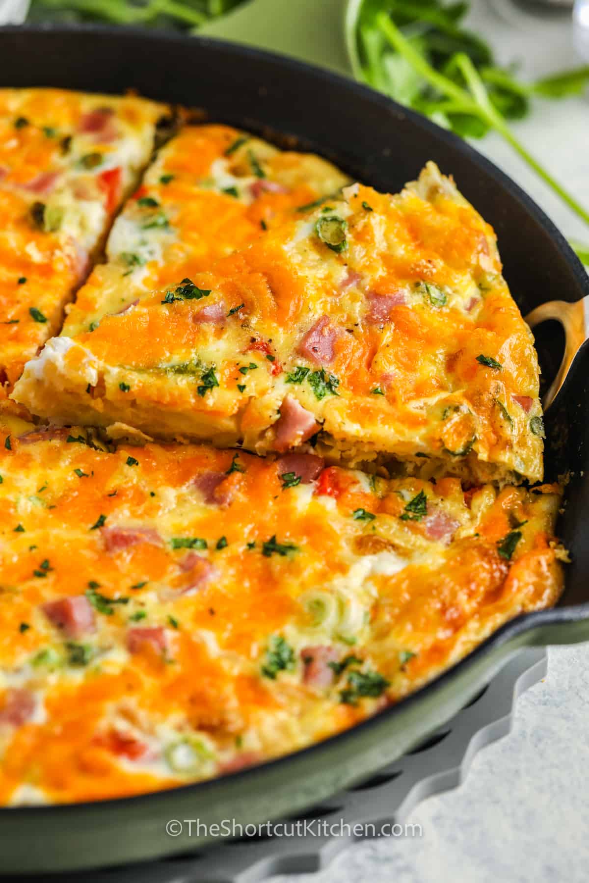 slicing an Easy Egg Frittata Recipe in the pan