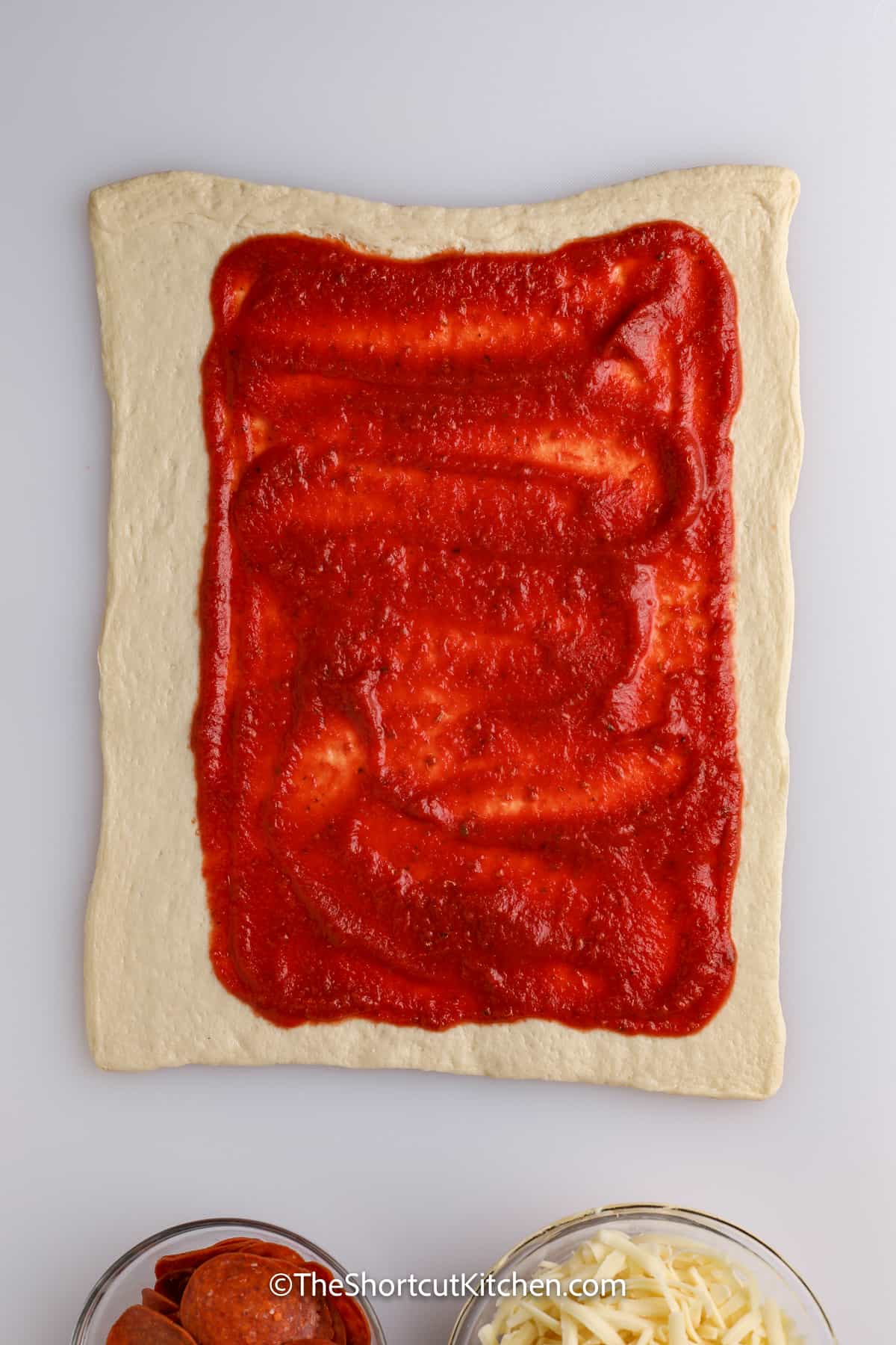 pizza sauce applied to crust