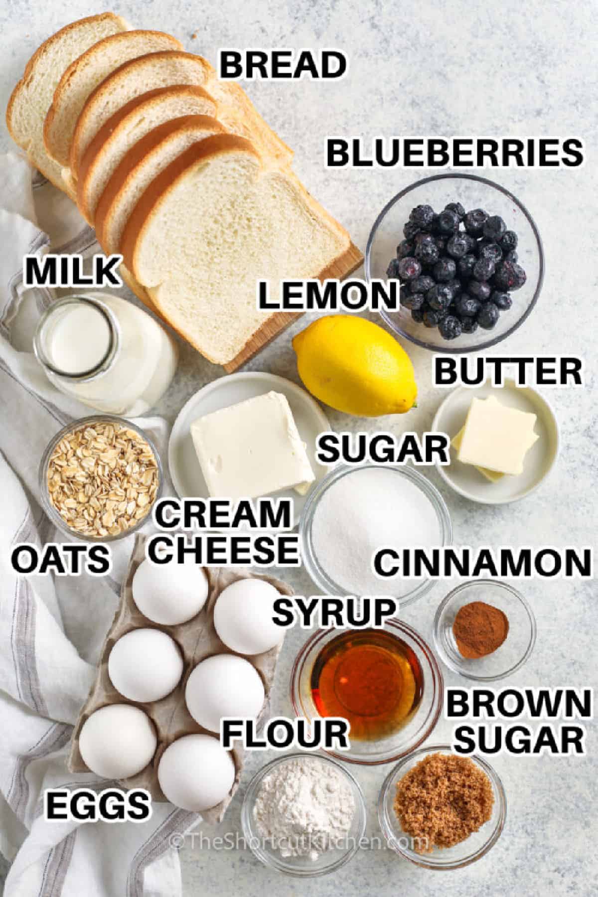 bread , blueberries , lemon , butter , sugar , milk , oats, cream cheese, cinnamon , brown sugar , syrup , flour and eggs with labels to make Overnight French Toast Bake
