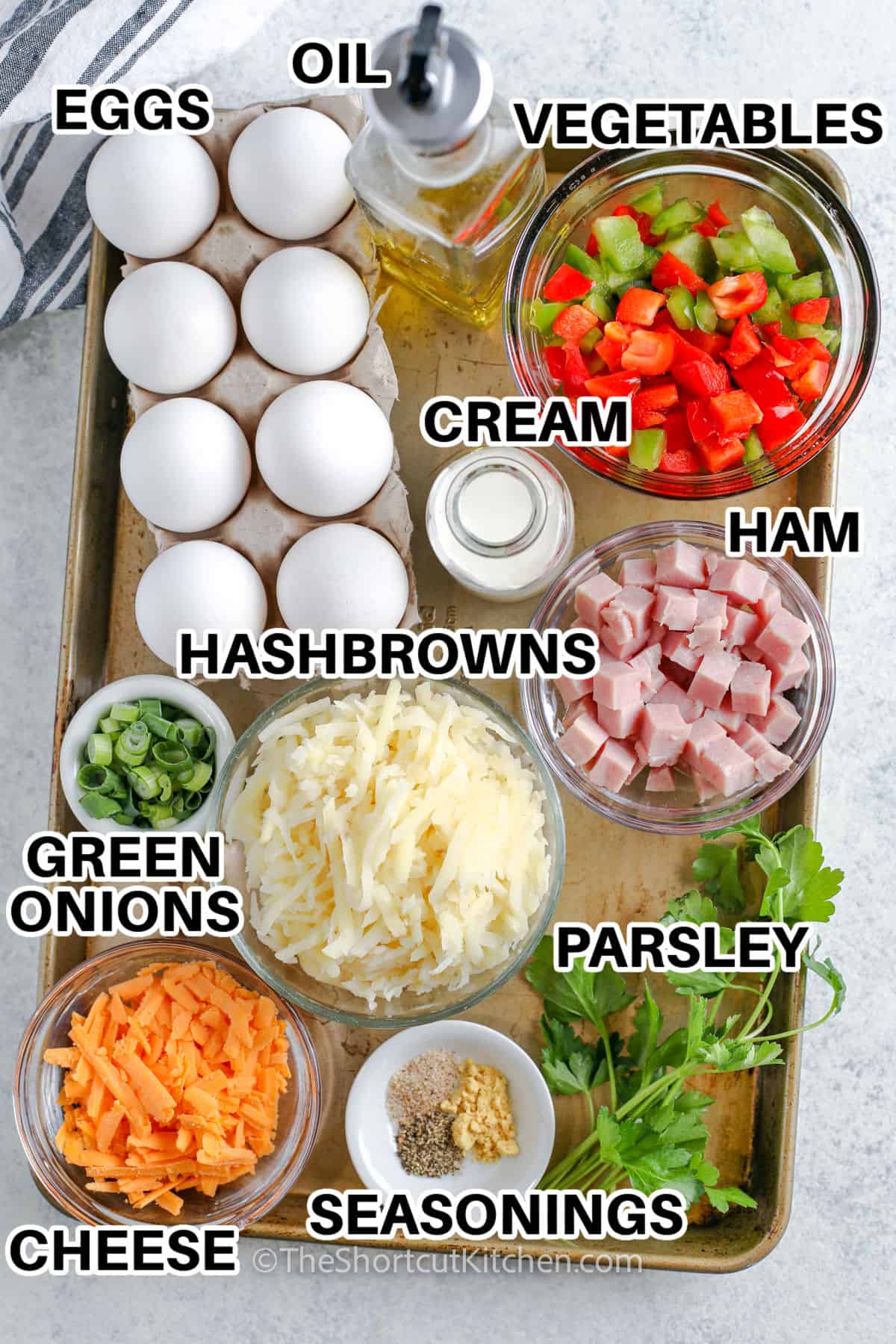eggs , oil , vegetables , cream , ham , hash browns , green onions , parsley , cheese and seasonings with labels to make an Easy Egg Frittata Recipe