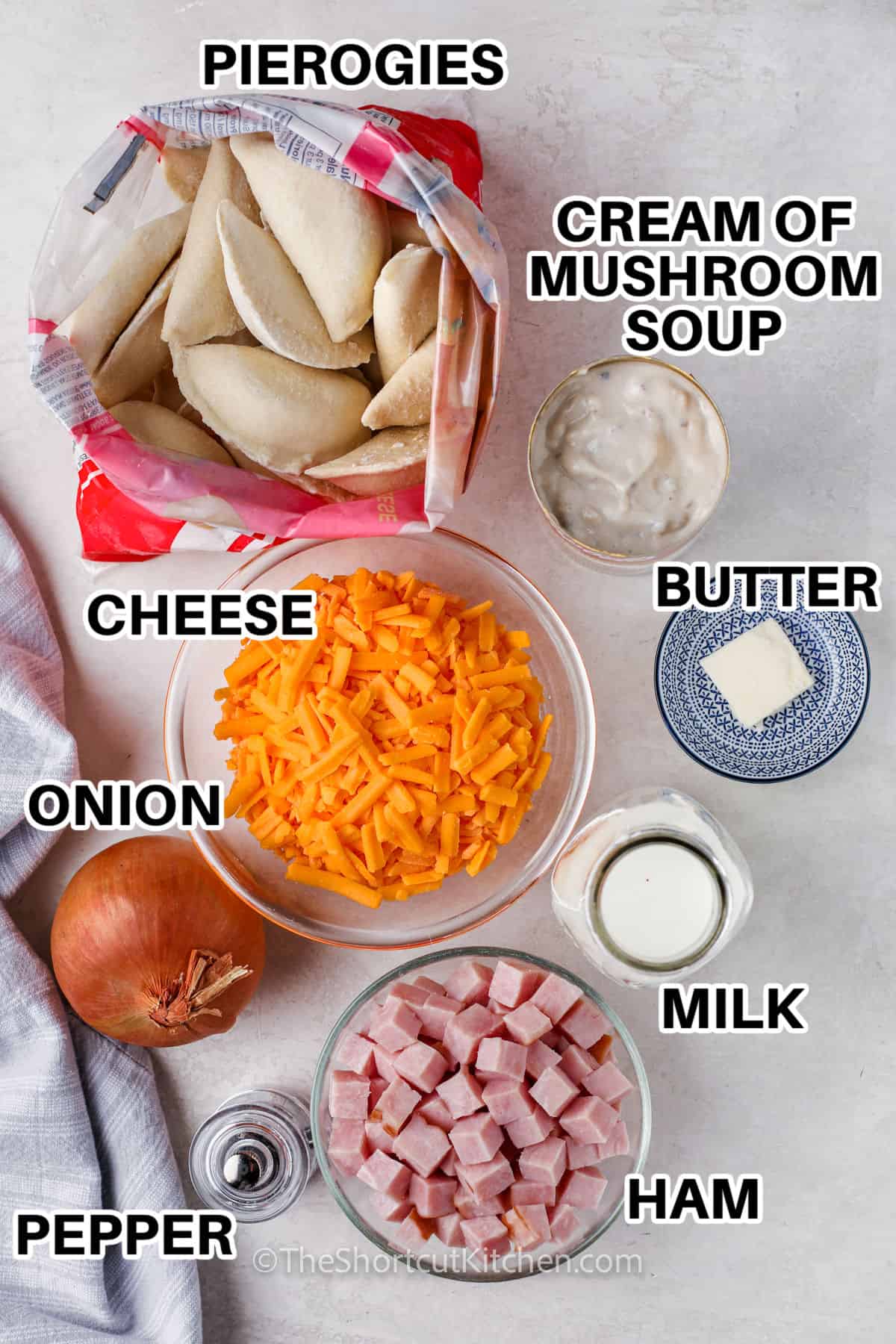 pierogies , cream of mushroom soup , cheese , butter , onion , milk , ham , pepper and an onion to make Pierogi Casserole with labels