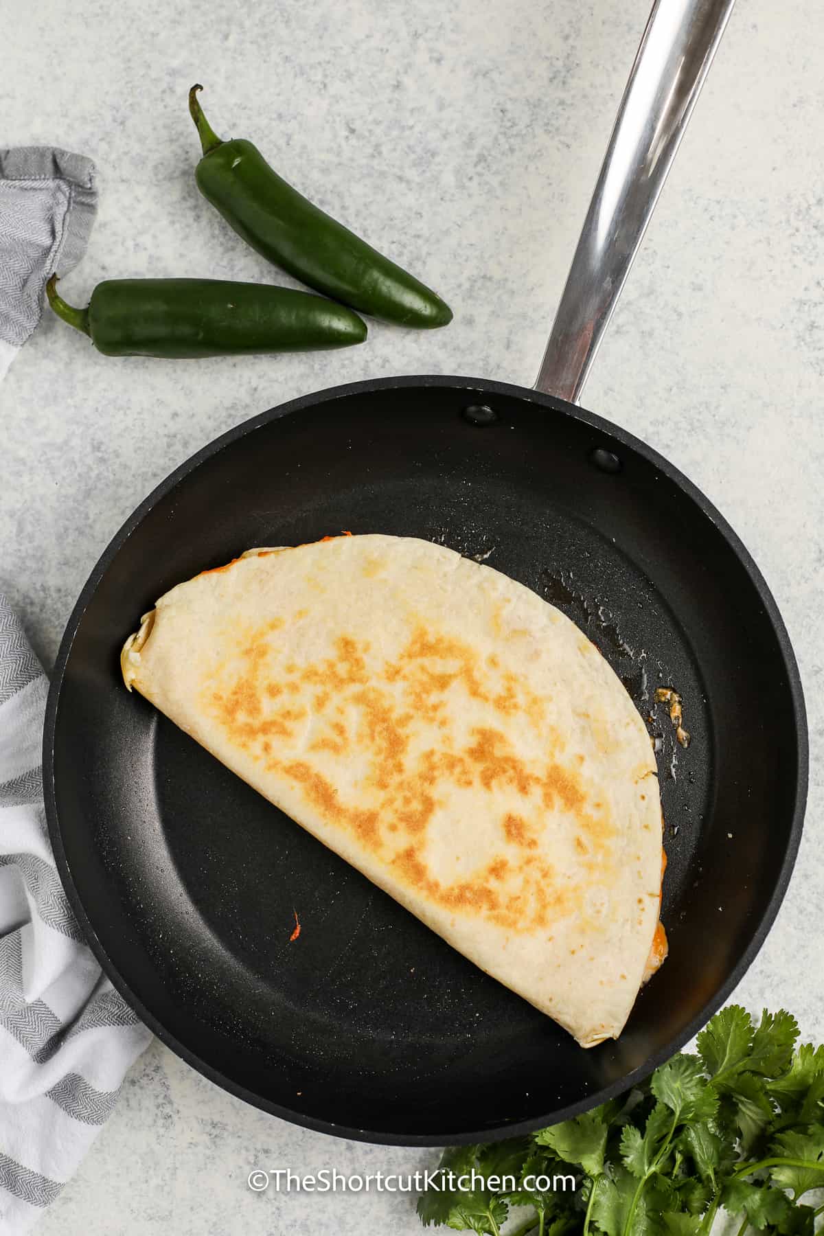 copycat taco bell chicken quesadillas being cooked on a frying pan